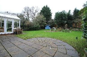 predominantly lawned private & secluded (not overlooked) rear garden with a further Indian slate circle paved area for sitting and enjoying the summer sun and winter sunshine with a cultivated area,