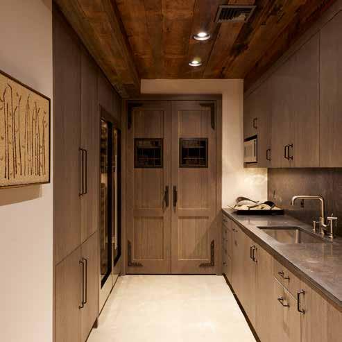 A wine room with a kitchenette can be found in the lower