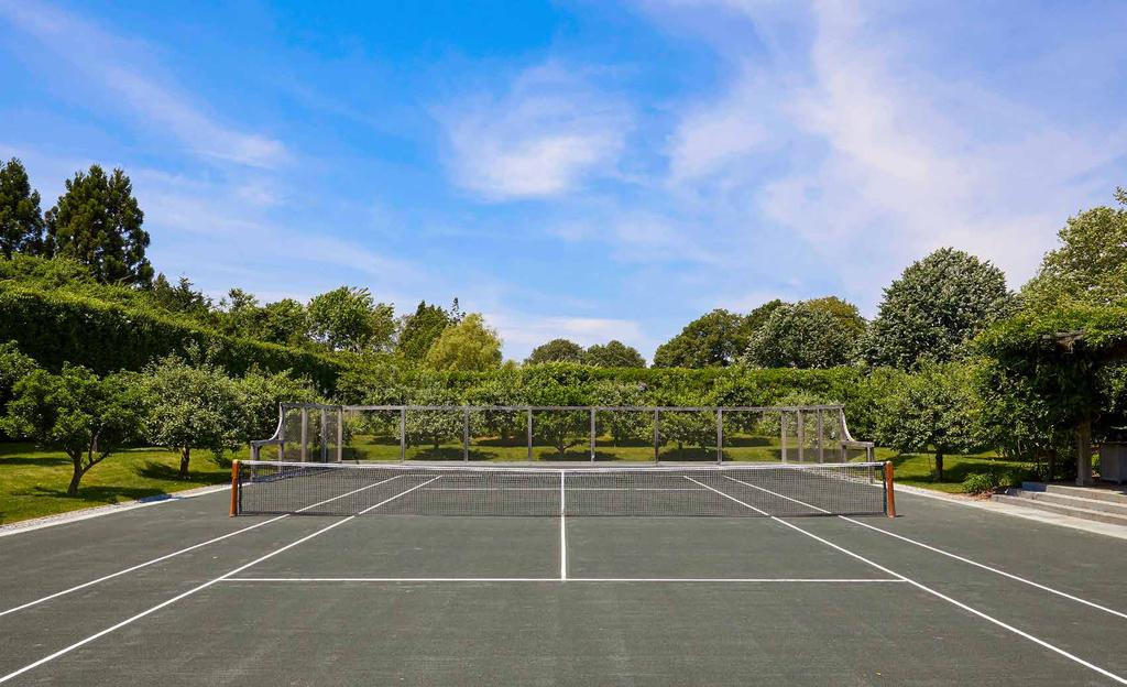 THE COMPOUND S GROUNDS SHOWCASE A TENNIS COURT WITH A FUNCTIONING APPLE CIDER ORCHARD THAT