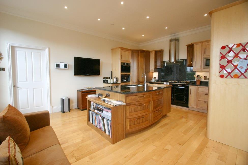 Wall mounted Nakamichi Sound Space 8 audio system covering the kitchen area and dining room. Maple wood strip flooring.