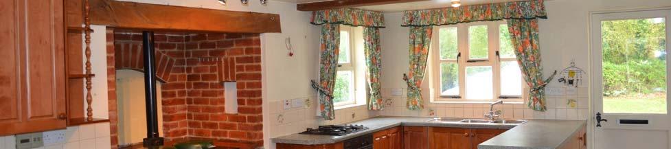 Fitted with an excellent range of base and eye level units comprising pine effect fronts with turned wooden handles.