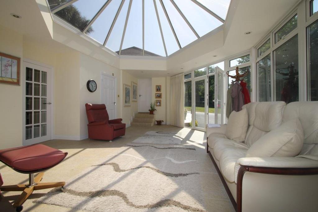 Hidden away along a long private lane Sarum enjoys a peaceful and semi-rural setting conveniently located on the outskirts of Town.