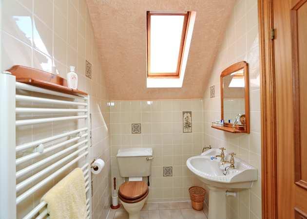 EN SUITE SHOWER ROOM Comprising a three piece suite of shower cubicle, WC and pedestal wash