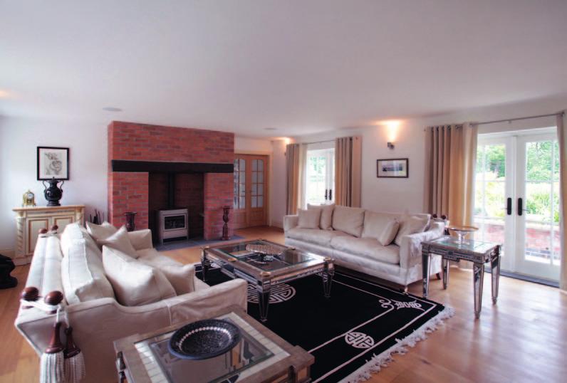 Drawing Room A large formal room with wood burning stove set within a substantial exposed brick chimney breast, and with an attractive aspect and two sets of French doors to the front terrace and
