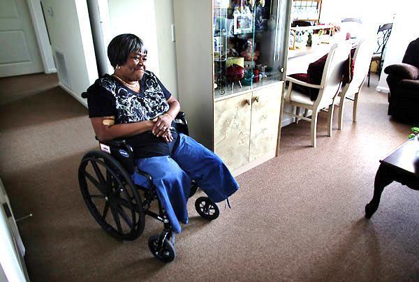 Margaret McNeil, 65, looks out across the spacious living room in her new Portsmouth home. Photo taken July 1, 2011.