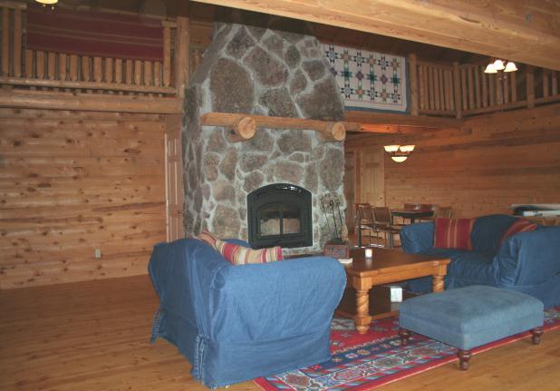 with native stone fireplace (quadra-fire unit with adjustable rheostat), dining area and kitchen.