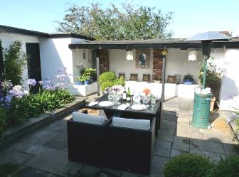 - A Beautifully maintained Courtyard with raised flowerbeds and seating, and a built in BBQ with chimney.