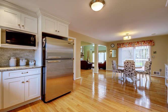 The recently updated, stylish kitchen features white cabinetry with