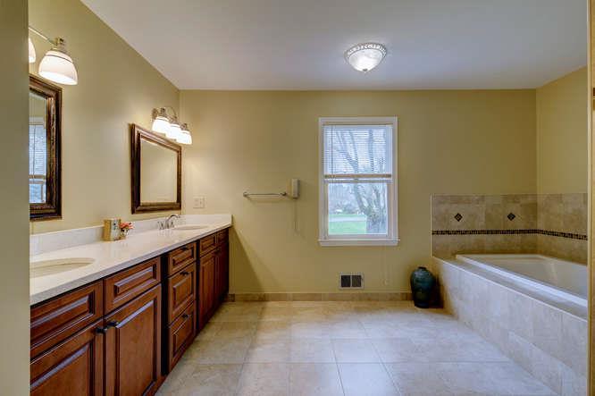 Designer tile touches distinguish this master bath from the rest, with inlaid tile