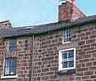 They are built in coursed stone with brick chimneys and are two storeys high, though number 58 has three storeys with the same roofline. Numbers 61 to 64 (consecutive) have dormers.