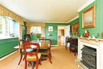 The Dining Room is a lovely room with a log burning stove, coir carpet and two windows.