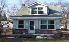 Remodeled kitchen and baths, newer roof and windows, gutter helmets. LOTS of storage and partially finished basement.