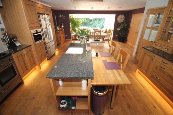 Kitchen/Diner: 24 7 x 16 1 Fully fitted high quality kitchen with central island in antiqued Oak.