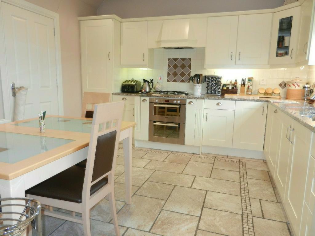 KITCHEN: 12' 9" x 12' 0" (3.887m x 3.663m) Excellent range of high and low level units in cream finish with polished granite worktops. Inset 1.5 bowl sink unit, mixer tap.