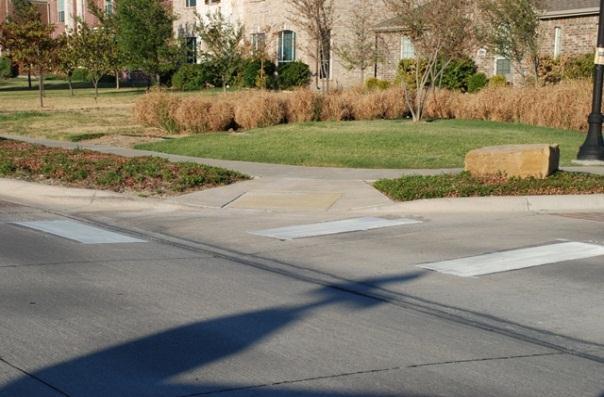 materials, such as brick pavers, to create clearly defined areas for pedestrians at crosswalks; or b.