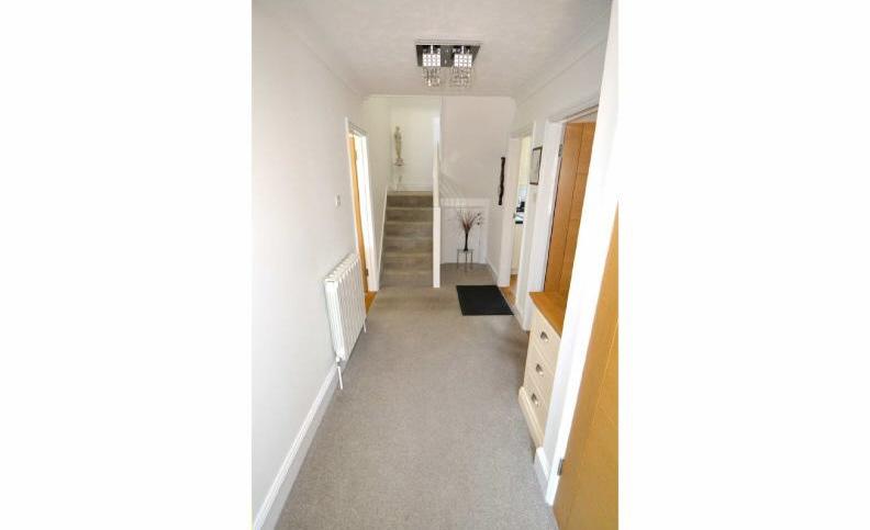 To the front of the property is a brick paved parking area and tarmacked area,