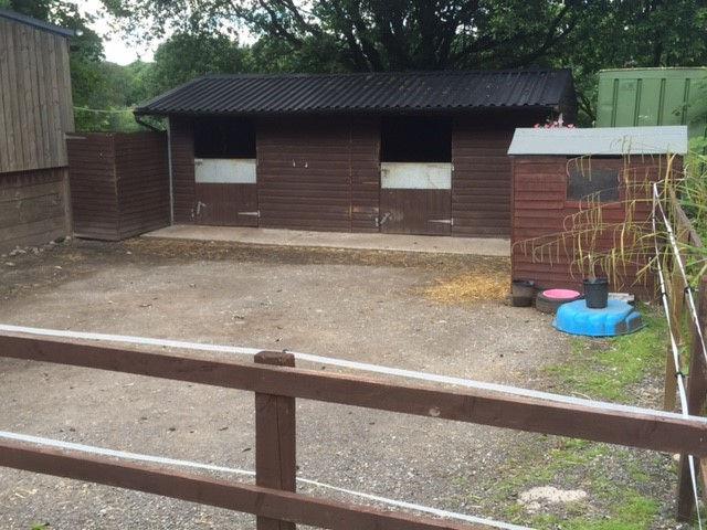 An equestrian yard with excellent facilities including floodlit outdoor arena, farm building, stables yard with separate toilet, ample hardstand car parking all set in approximately 6.