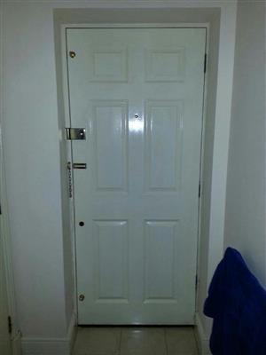 safety chain and spy hole, door frames wooden painted white.