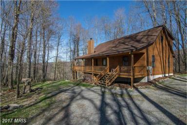 This home offers an open floorplan, wrap around partially covered deck, three levels of living space, integral garage and flagstone floor covering on the lower level.