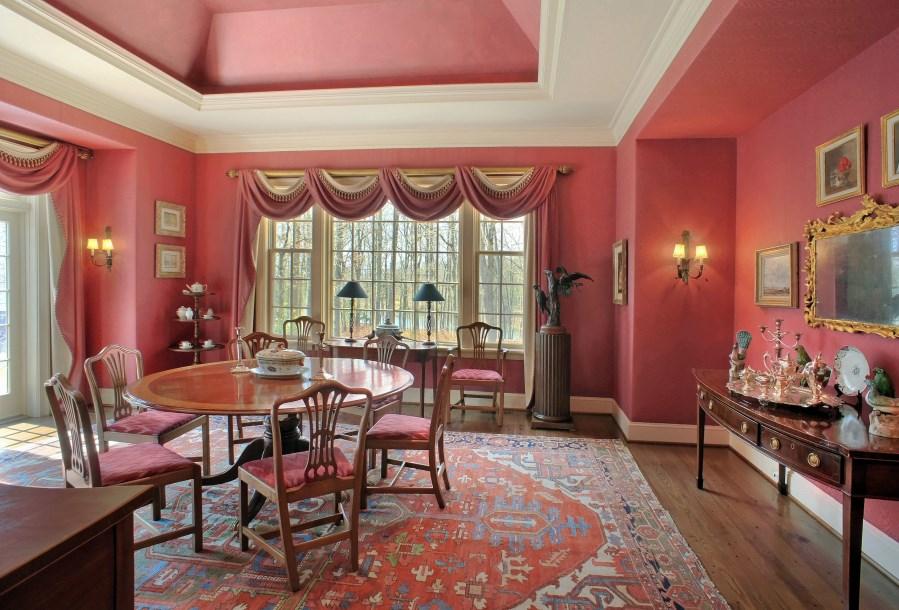 FIRST FLOOR FEATURES DINING ROOM W ood floor; silk-dressed walls; tray ceiling with recessed lighting; a picture window overlooking the