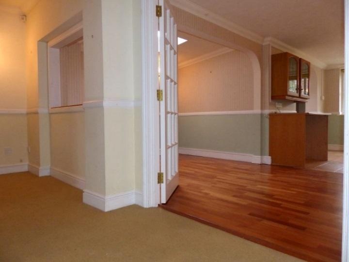 radiator, hallway behind sitting room measures 14 x 4 From the rear hallway, double doors open to the: Dining Area 9 x 6 10 Skylight, hardwood flooring, radiator, Walk-Though Lobby With matching base