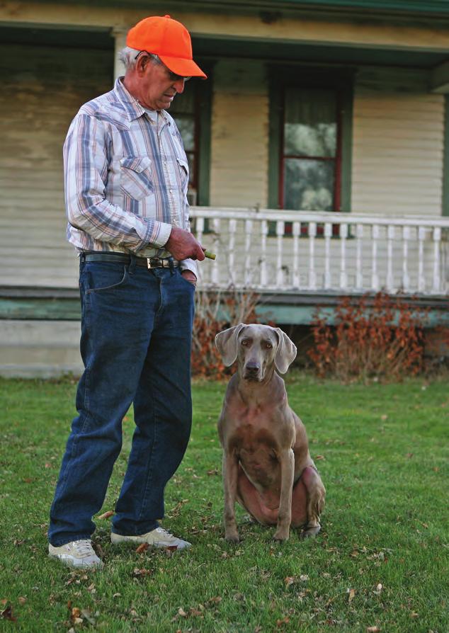 Bill Saylor (left) poses with his dog Suzy. He taught me much of the history of Lily before he passed in 2013, says Christopherson.