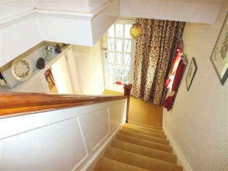 and a double power point. An attractive panelled staircase within the hall leads to the first floor.