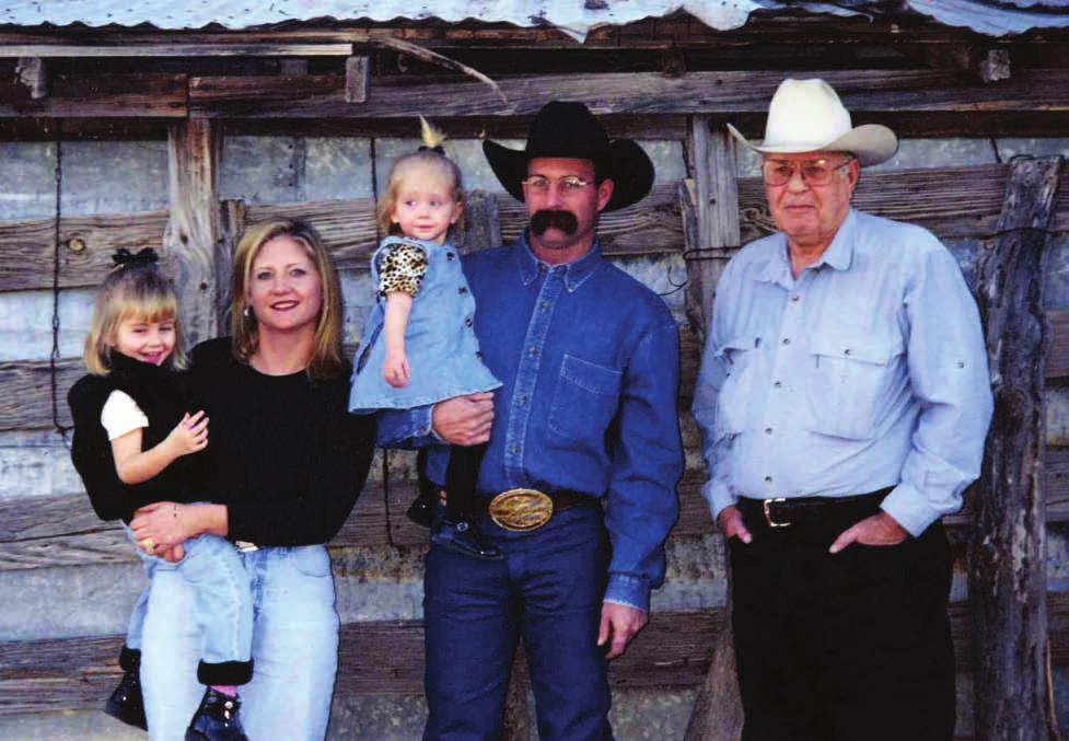 (Left to right) Julie McIvor holding daughter Locke Ann, Scott McIvor holding daughter Mae and Don McIvor, Christmas 2000 on the ranch.