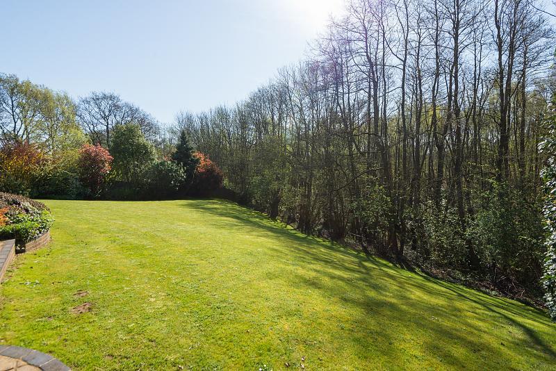The rear garden is one of the biggest on this small cul-desac and has a gradual, lawned slope which backs onto woodland.