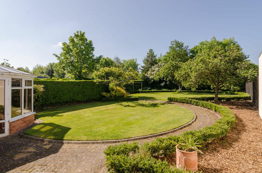 GARDENS: Formal garden area to front with parking