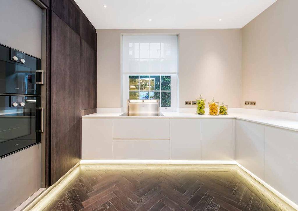 The bespoke kitchen is fitted throughout with a range of