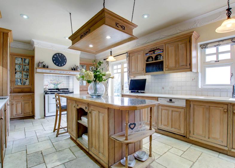 oven Aga with twin hob with built in glazed dressers each side. The breakfast room is accessed from the kitchen via an open archway.
