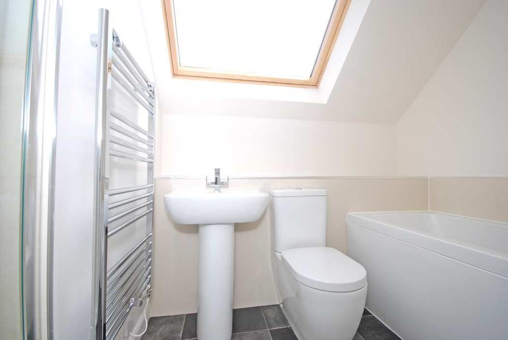 FAMILY BATH & SHOWER ROOM Velux style window to the side. New white bathroom suite.