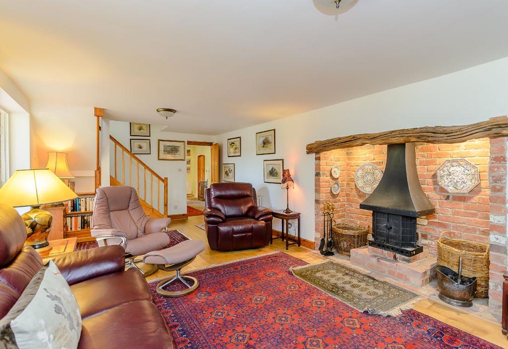 23 sitting room with log burner, door to study (with views of the stables) and double doors through to a superb 20 bespoke conservatory with tiled floor and doors