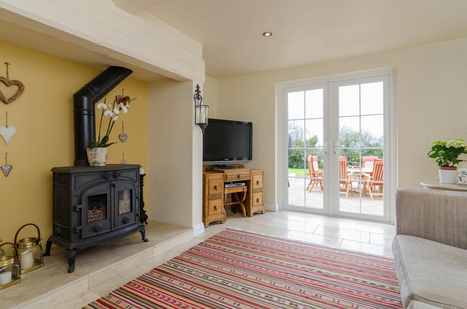 beams, inglenook fireplace with multi fuel stove, french double doors open to rear garden.