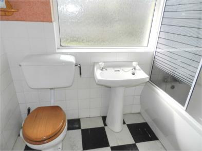 BATHROOM Having a three piece suite comprising of panelled bath with shower screen and Gainsborough shower,
