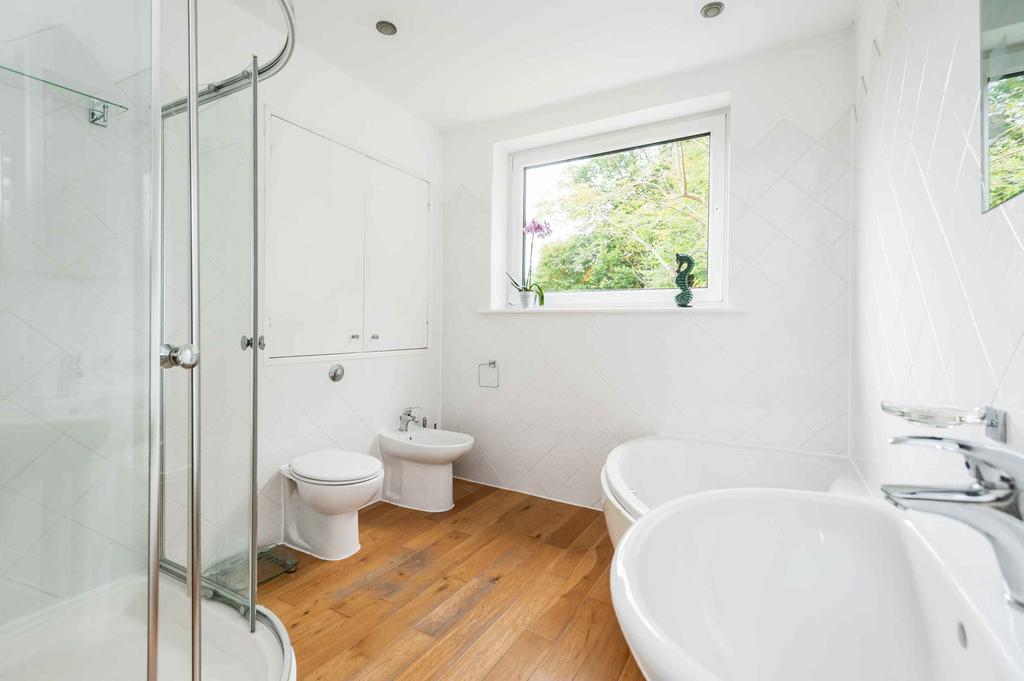 Stairs lead from here to a large attic bedroom with a modern en suite shower room.