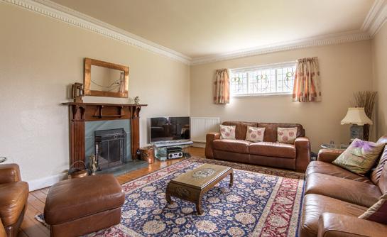 Living Room: With southerly facing window. Carved oak fire surround. Marble insert and hearth. Gas fire.