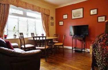 Off the hallway is a sizeable sitting room complete with a burner and patio doors leading out to the rear garden, a dining room, study / fifth bedroom, wet room and a kitchen with a large adjoining