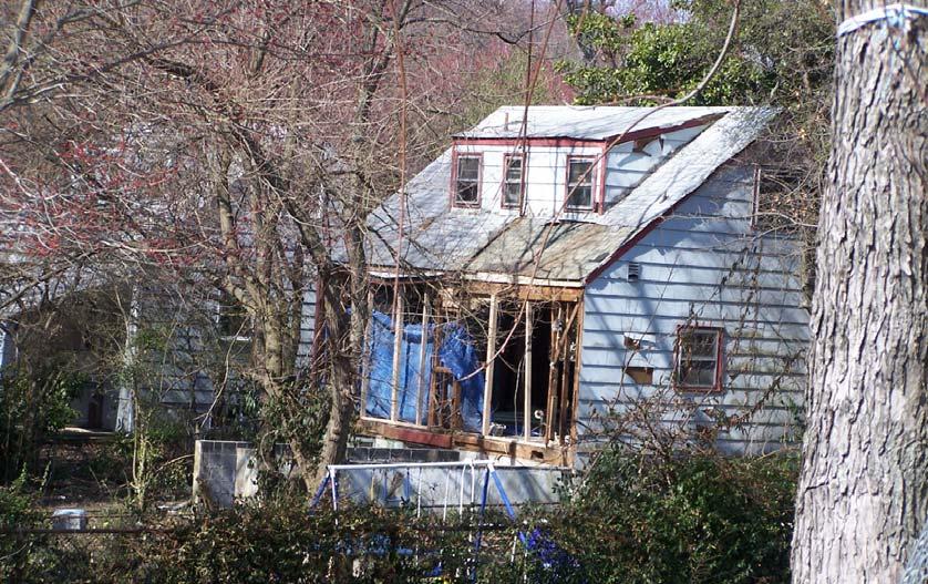 SPOT BLIGHT BEFORE ENFORCEMENT Structure was left vacant after owner died.