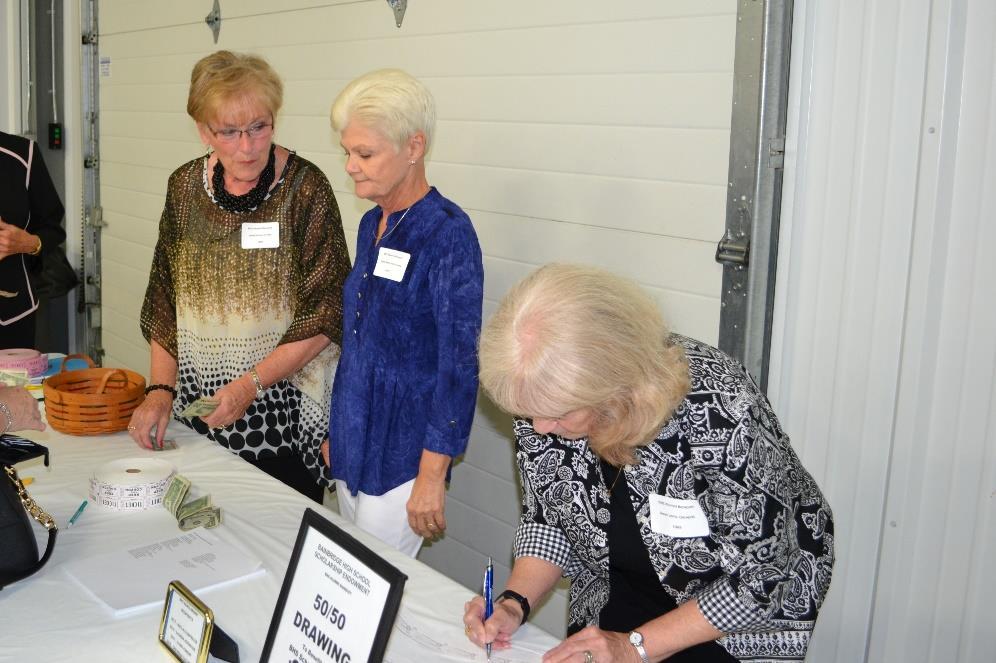 Helping at the Scholarship Committee 50-50 table are (L-R) Janet Houser O Hair (BHS
