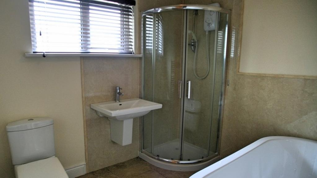 cubicle. Extensive wall fitments with mirrored sliding doors. Double room with built in robe.