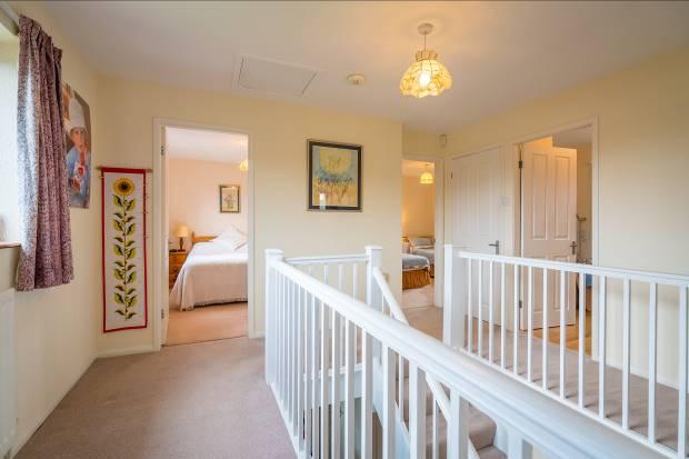 The Master Bedroom overlooks the countryside on two aspects, with almost an entire wall providing built-in cupboards, and an adjacent Shower Room with a shower cubicle, w.c., sink, vanity unit and heated towel rail.