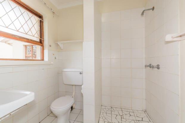 The bathroom is tiled on the floor and halfway up the walls.