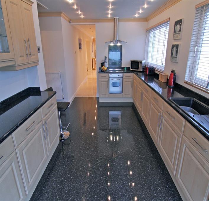 electric hob, stainless steel extractor fan with glass surround, integrated dishwasher, integrated fridge, integrated freezer, two PVC double glazed windows with panoramic views across the rear