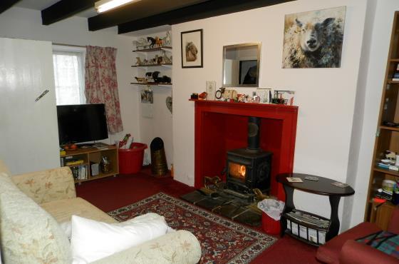 set on a tiled hearth, exposed beams, radiator,