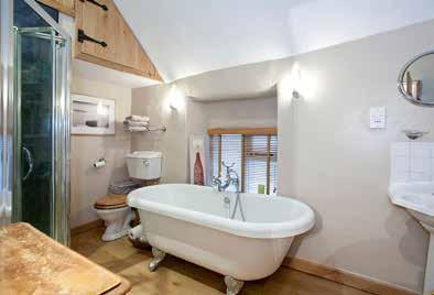A walk in wardrobe provides hanging rail and shelving. Also with radiator and exposed beam. ENSUITE SHOWER ROOM Comprising shower enclosure with glazed screen, vanity wash hand basin and low flush WC.