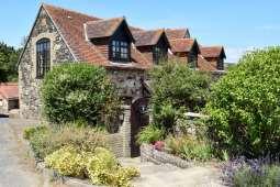 Introduction 2 The Granary is located on the edge of Brighstone village, 500m from the village centre and 500m from the beach at Grange Farm.
