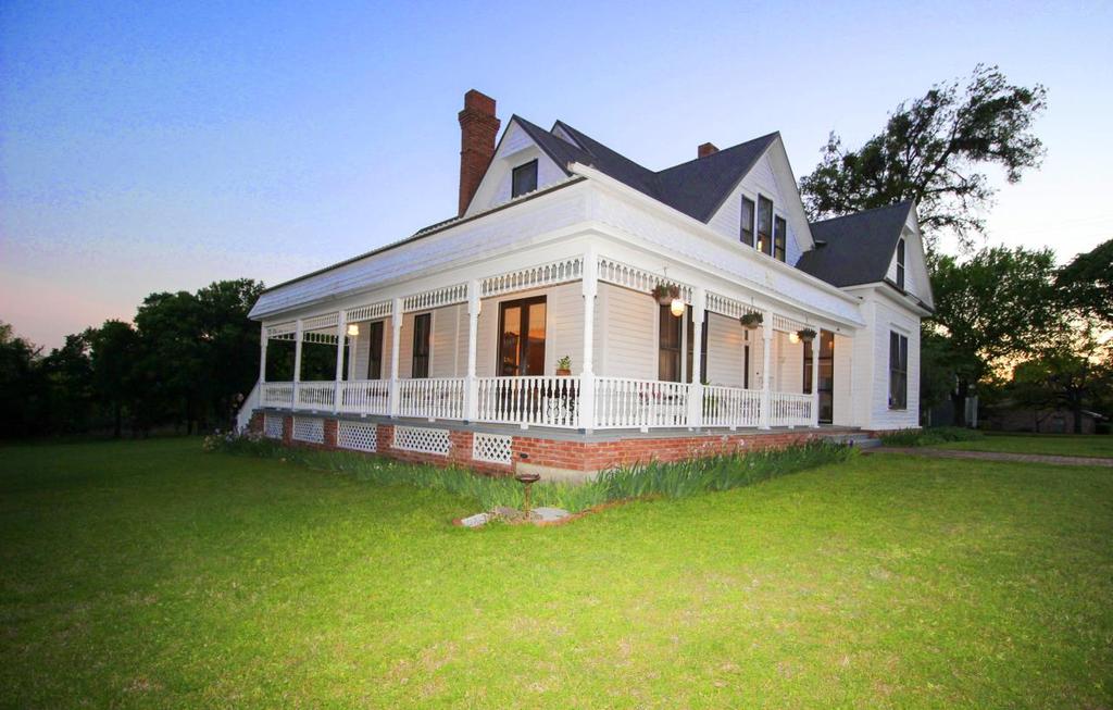 Step back into history as you walk down the brick sidewalk to the wrap around porch of this Victorian home.