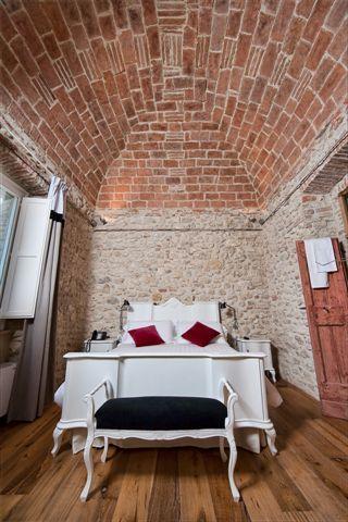 The bedroom has an ancient stone vault
